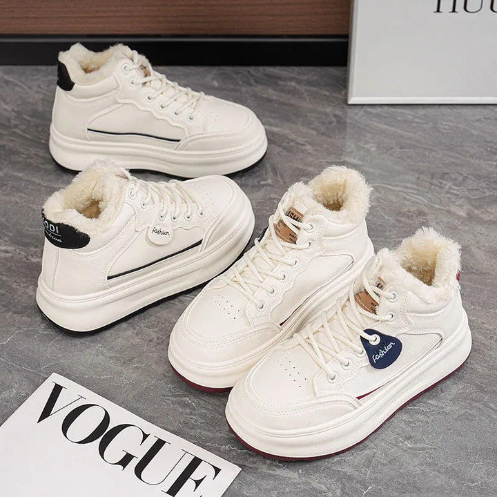 Pair of white lace-up platform winter sneakers with plush fur lining and thick sole