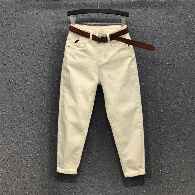 High-waist wide-leg jeans in pale cream, with brown belt and button waistband