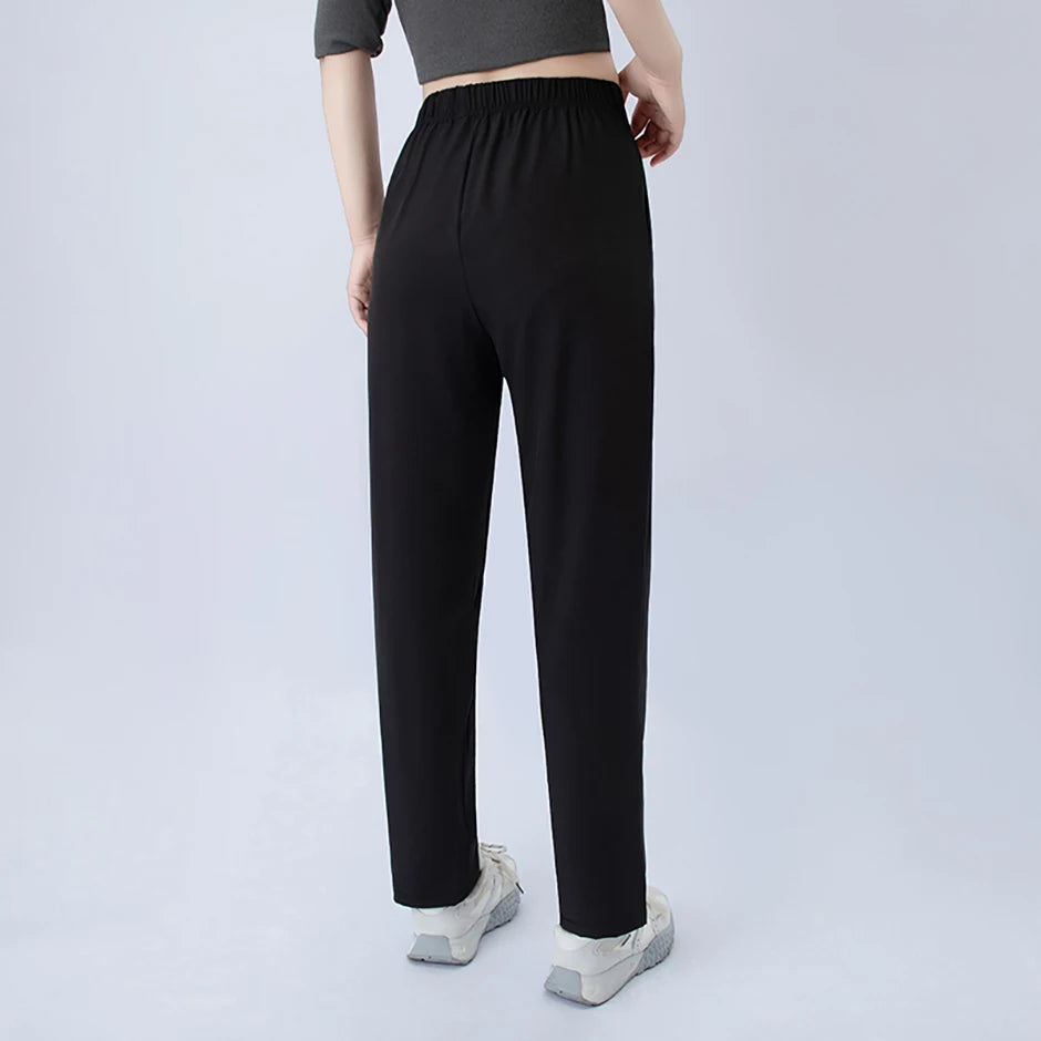 Back view: black wide-leg pocket pants with elastic waist