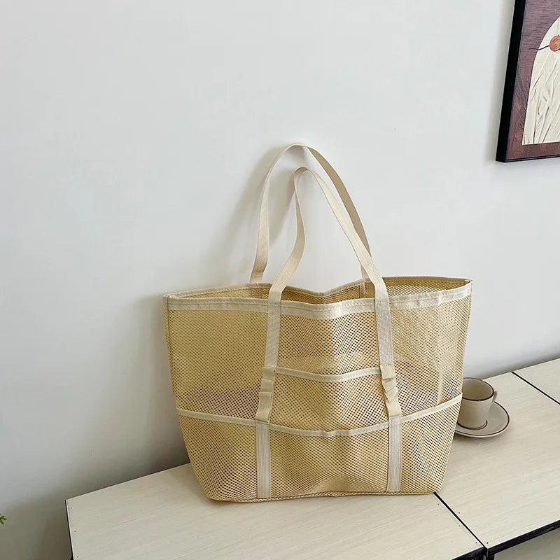 Beige sheer mesh tote bag with open top and wide straps, front panel details