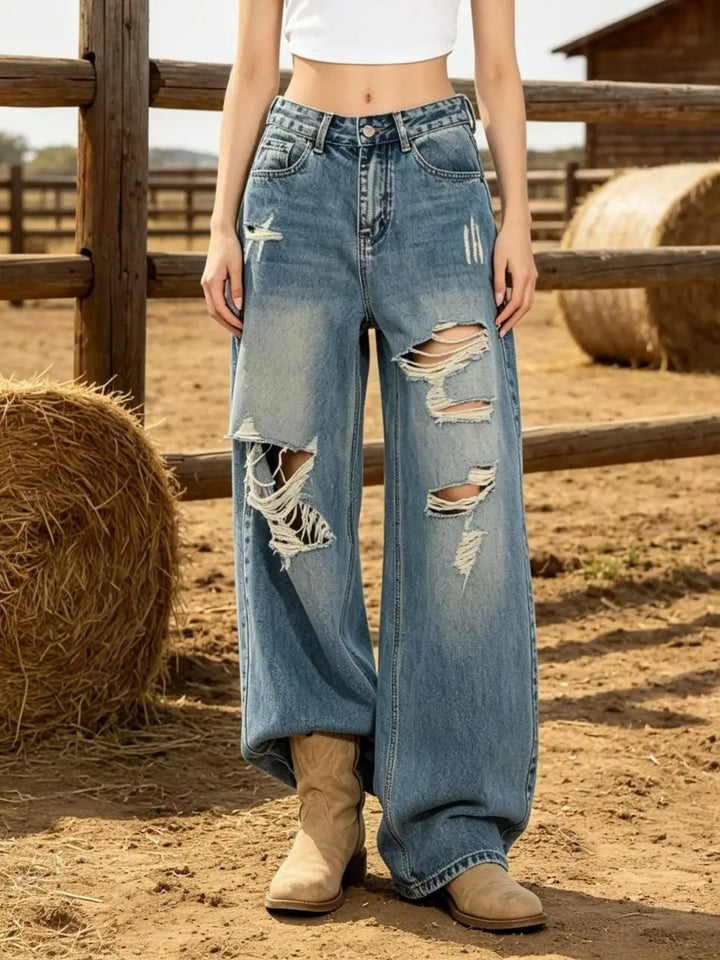Women’s high-waist light blue relaxed jeans with large ripped holes and frayed trim