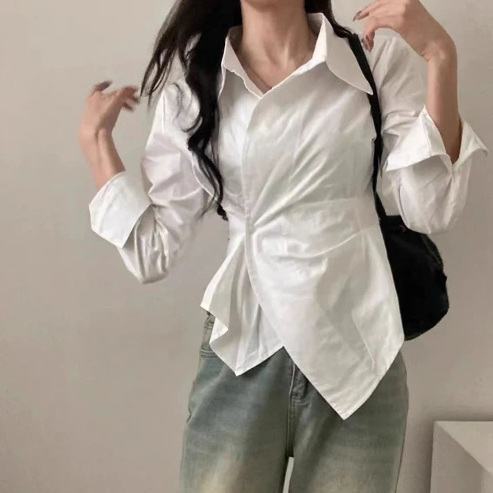 White slim-fit blouse with ruffled pointed collar and long cuffed sleeves