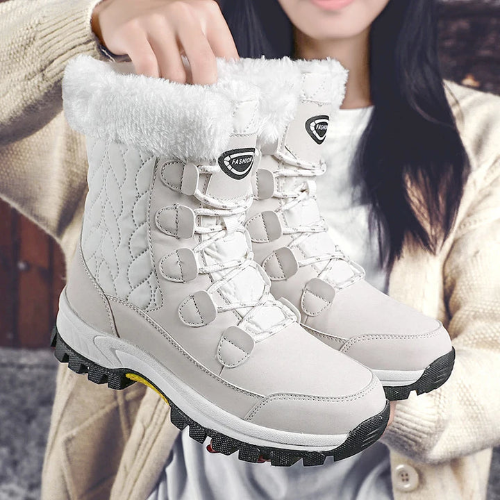 Women's white mid-calf lace-up snow boots with thick fleece lining and grippy outsole