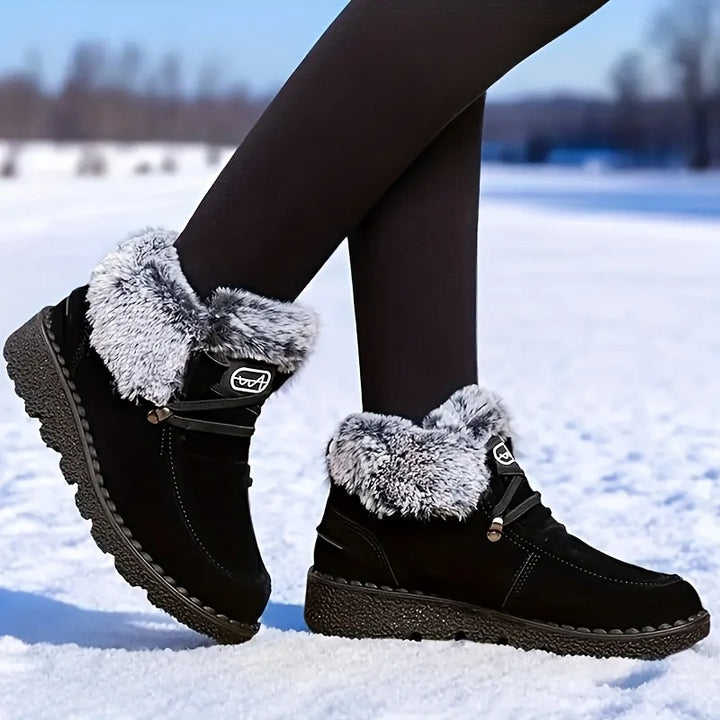 Women's black lace-up snow boots with fuzzy cuffs and textured lug sole