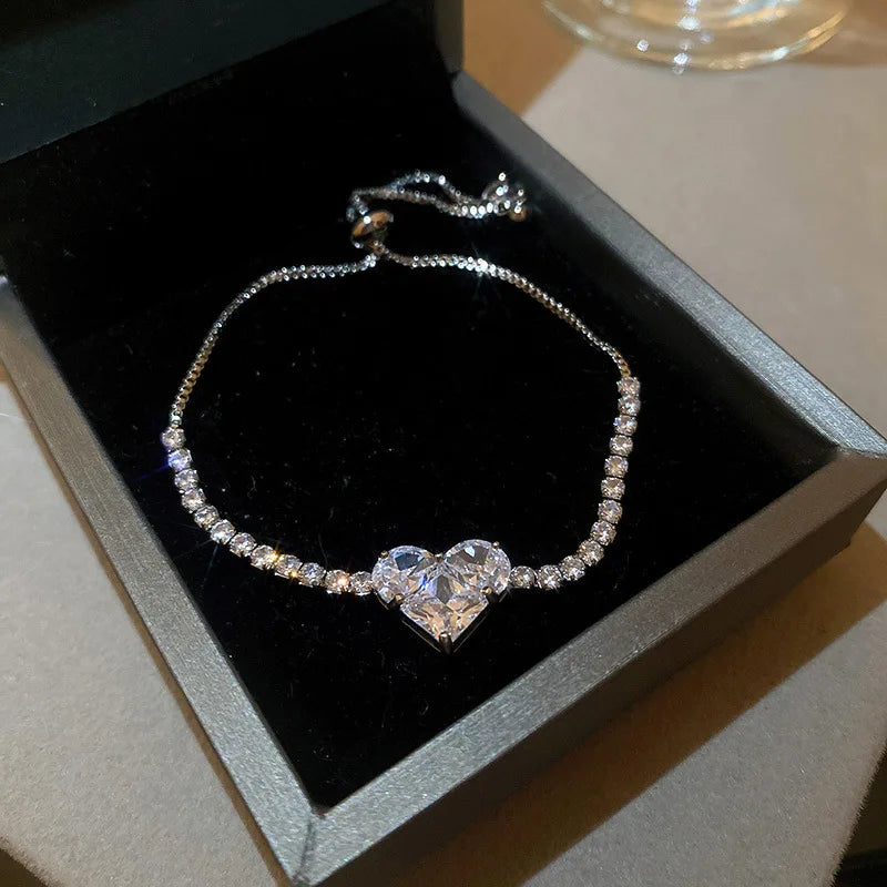 Silver-tone heart zircon bracelet with prong-set stones on a fine chain