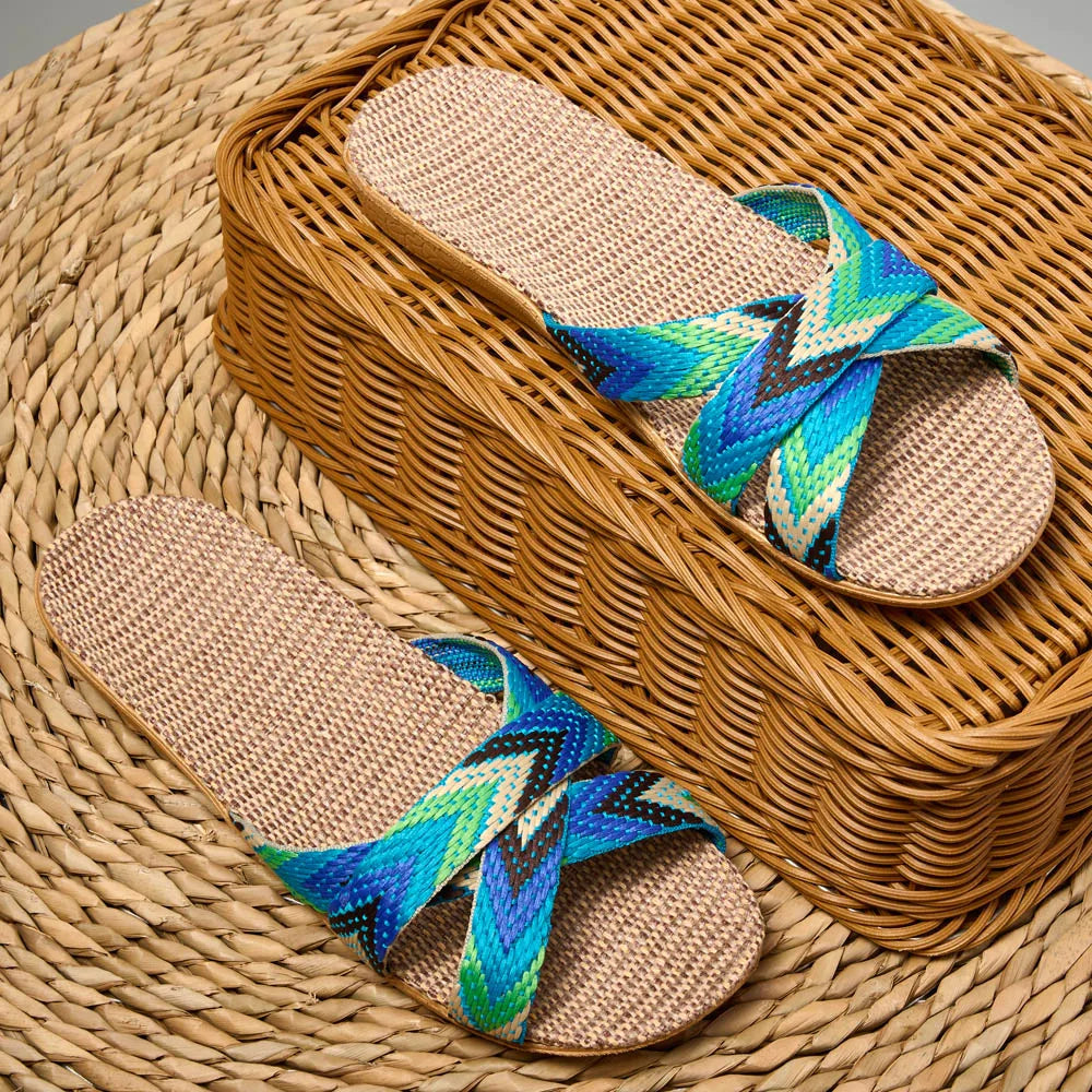 Pair of sandals with colorful straps on a woven surface
