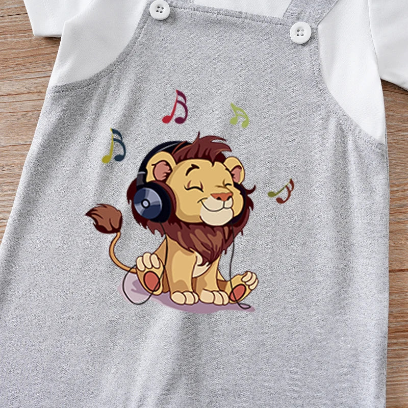 Gray romper with a cartoon lion wearing headphones and music notes on a wooden surface