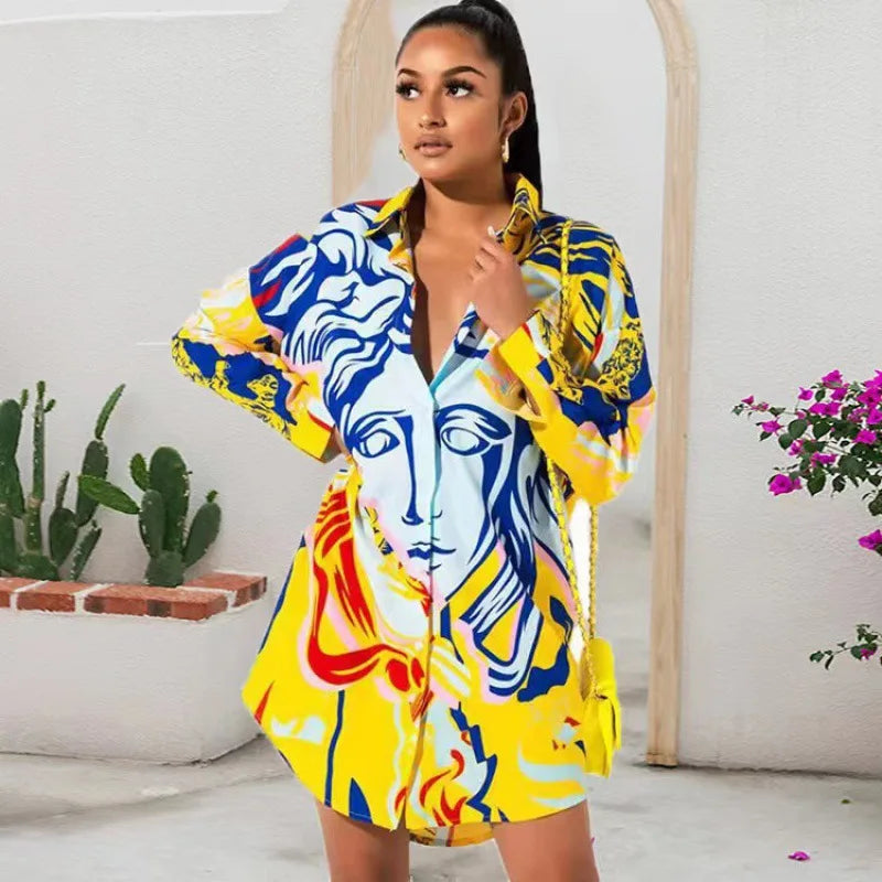 Woman wearing a colorful dress with artistic design in a room with plants and flowers.