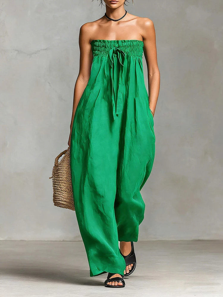 Green strapless dress worn by a person against a neutral background