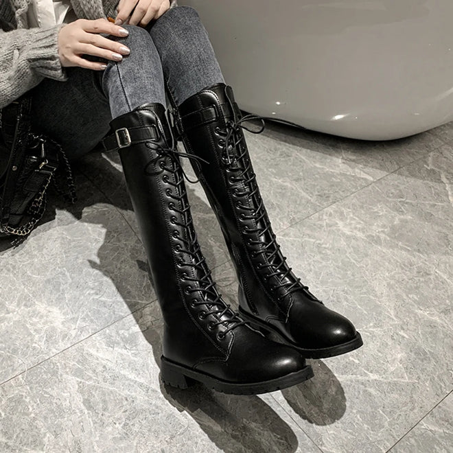 Black knee-high lace-up boots with thick lug sole and tall shaft
