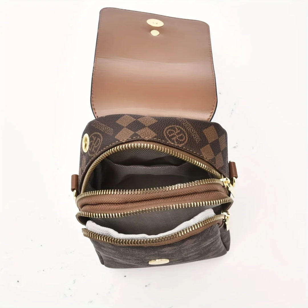 Brown leather handbag with gold zippers on a white background