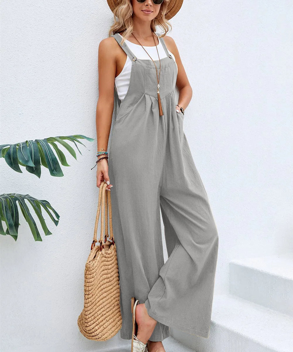 Gray sleeveless jumpsuit with adjustable straps, tie detail at the bust, wide legs