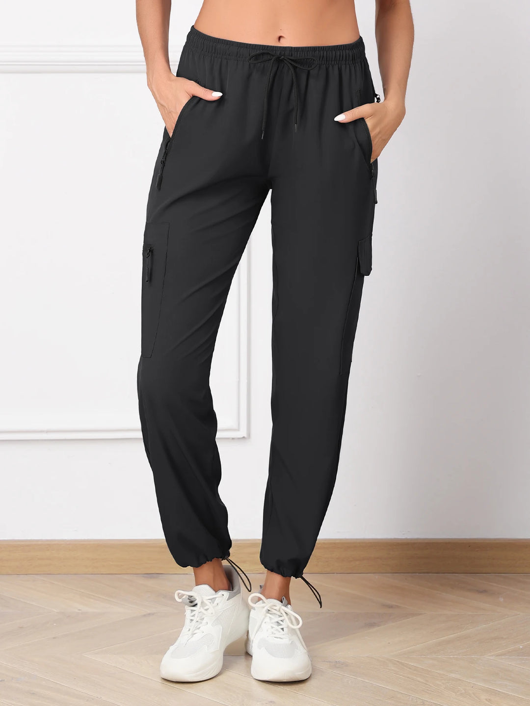 Women's Black Regular Fit Cargo Pants Front View With Hands In Pockets