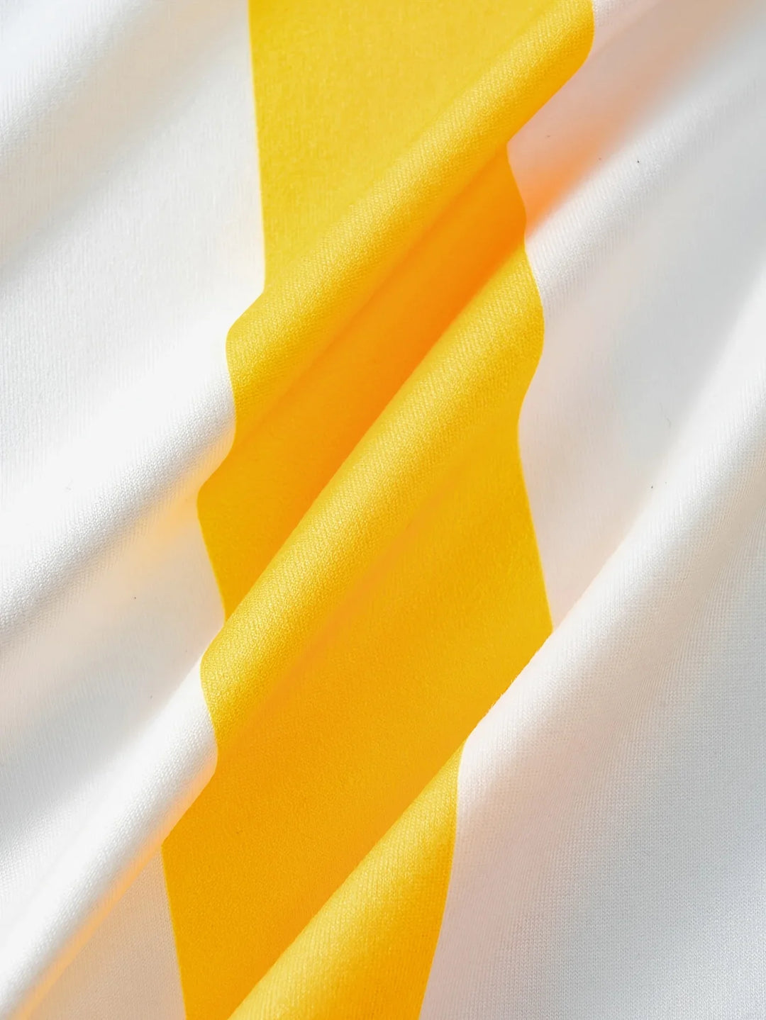 Close-up of yellow fabric with a white background