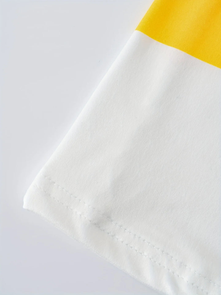 Close-up of a white and yellow fabric with a textured pattern on a light gray background