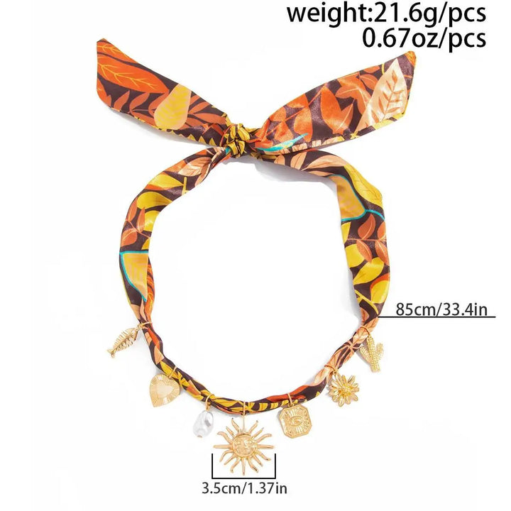 Turquoise or orange leaf print scarf necklace with gold-tone sunflower heart charms