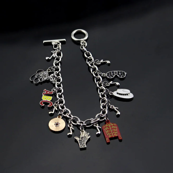 Silver-tone charm link bracelet with ABC letters, red jacket, white oval face, guitar, hand, coin
