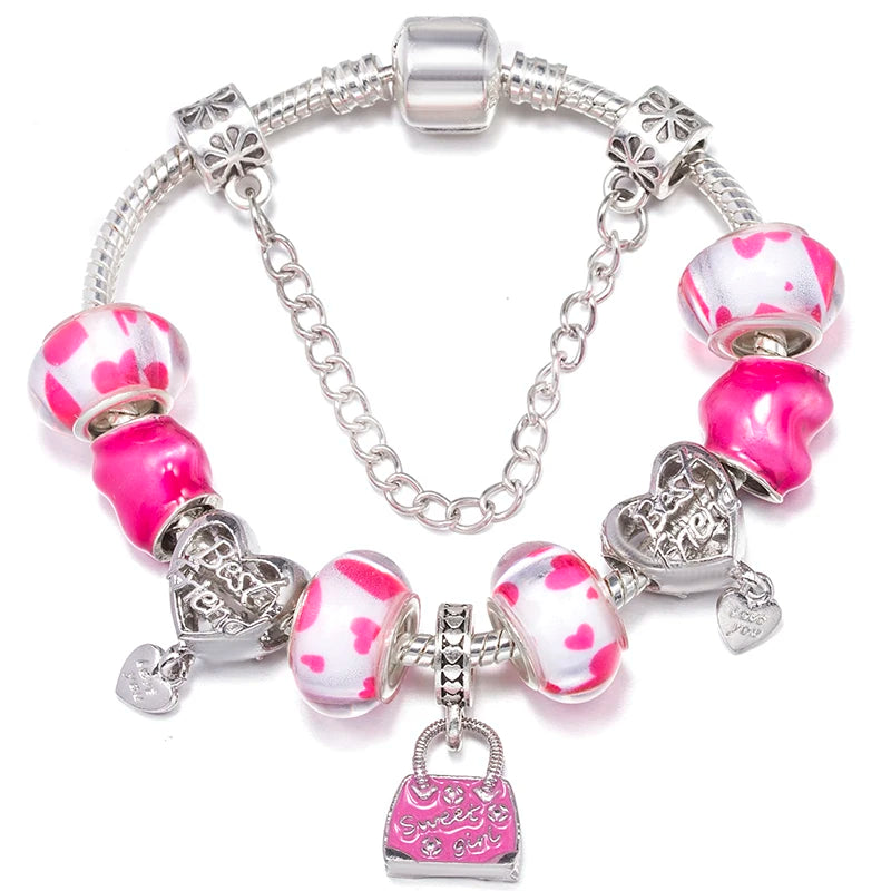 Silver charm bracelet with pink and white spotted beads, a small bag charm, and hearts