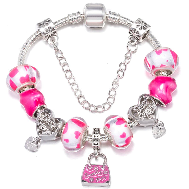 Silver charm bracelet with pink and white spotted beads, a small bag charm, and hearts