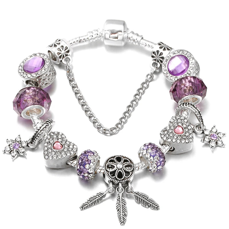 Silver charm bracelet with purple beads and heart and bag charms, plus feather-like dangles