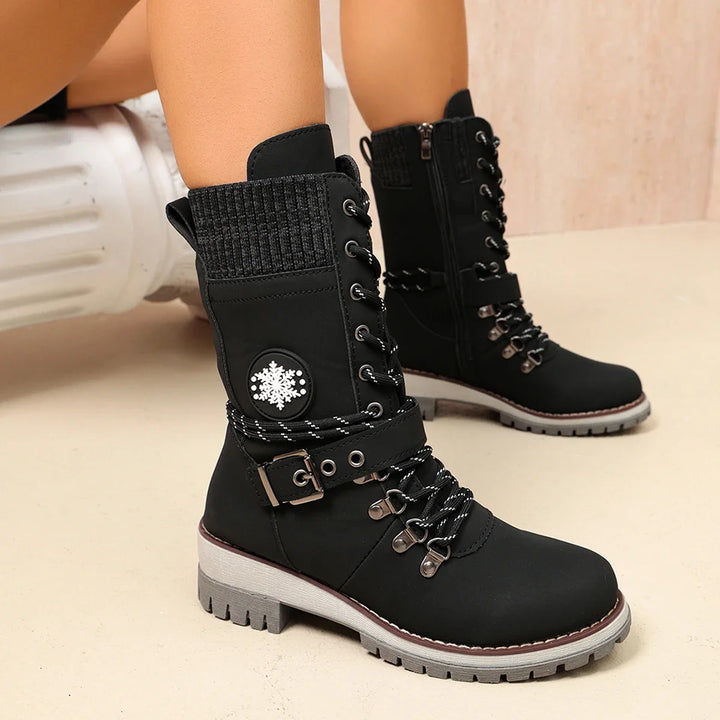 Women’s black lace-up winter boots with plush-look collar lining and chunky tread sole.