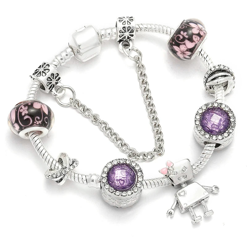 Silver-tone bracelet with purple crystal charm, patterned beads, and heart clasp