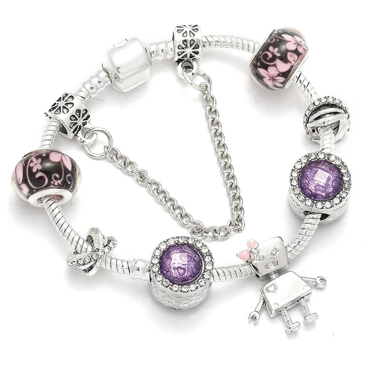 Silver-tone bracelet with purple crystal charm, patterned beads, and heart clasp