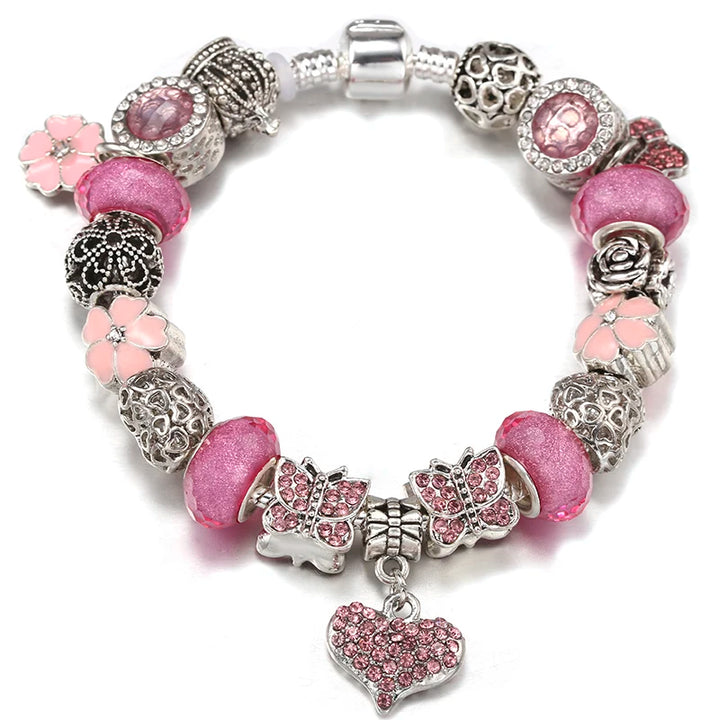 Silver charm bracelet with pink beads, flower accents, and pink heart pendant