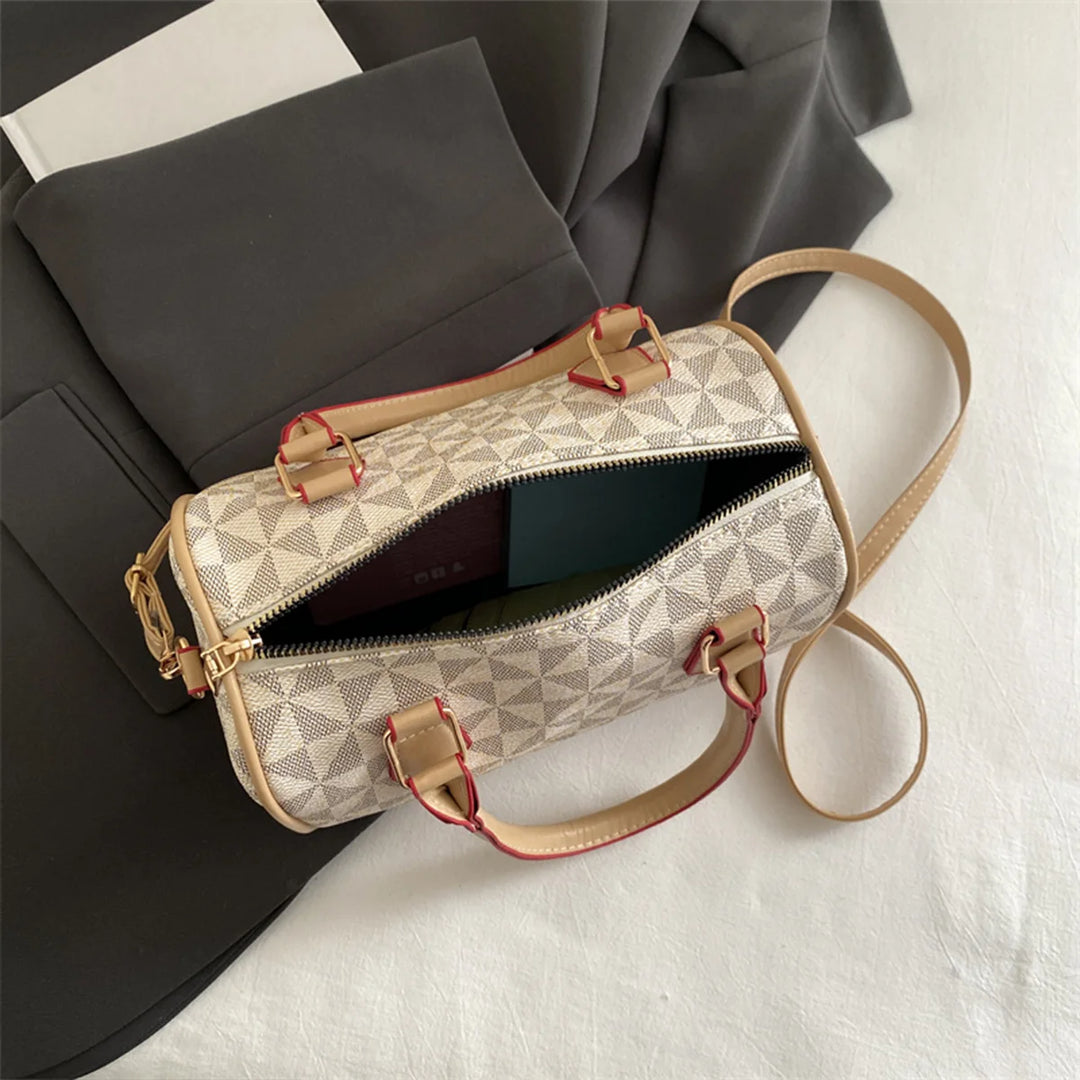 White PU crossbody handbag with geometric triangle print, zip-top, and adjustable shoulder strap