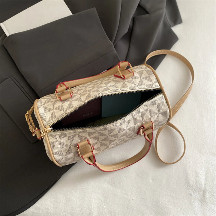 White PU crossbody handbag with geometric triangle print, zip-top, and adjustable shoulder strap