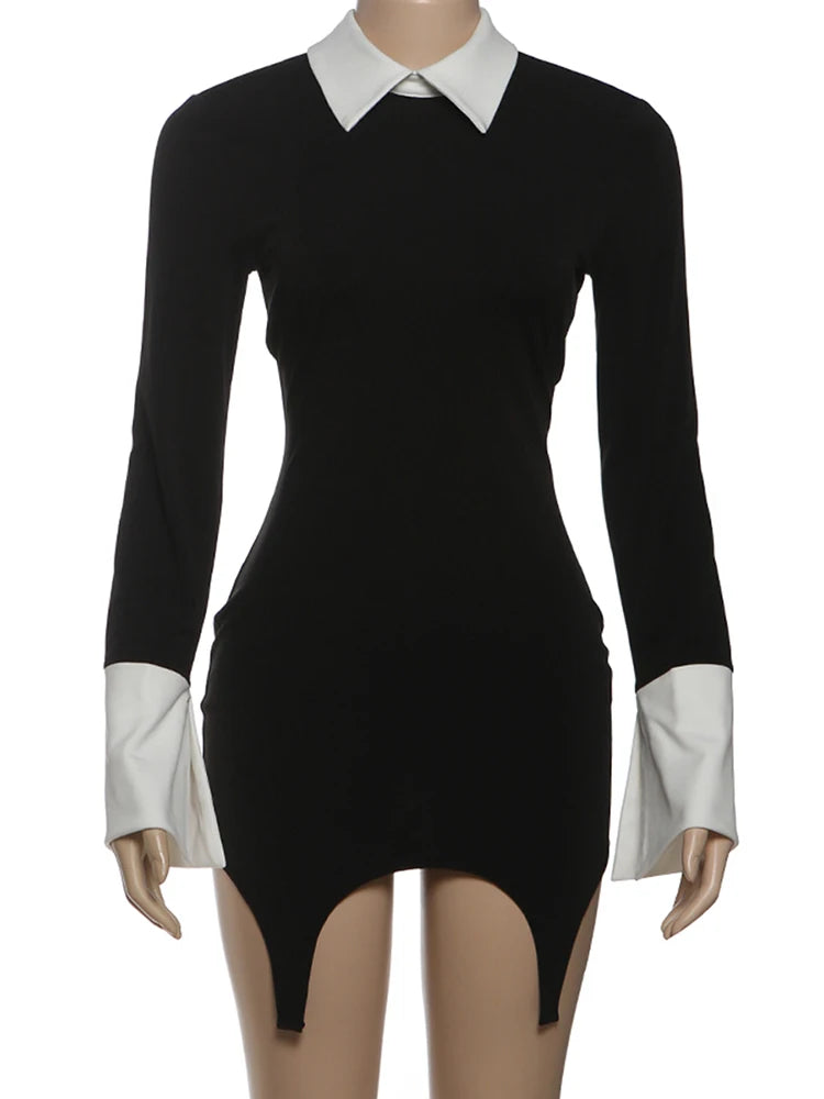 Black dress with white collar and cuffs on a mannequin against a white background