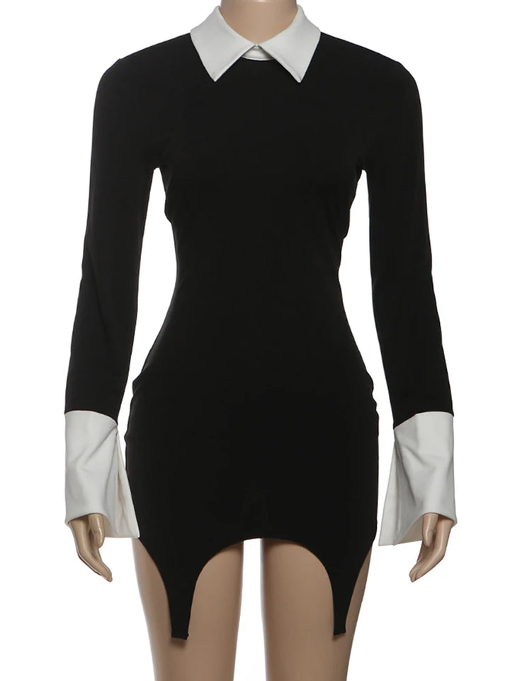 Black dress with white collar and cuffs on a mannequin against a white background