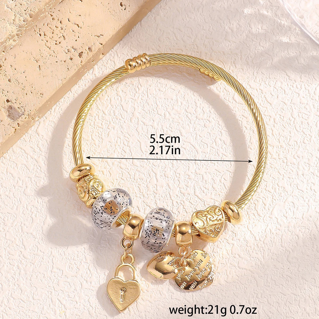 Beaded bangle with copper-tone charms, heart padlock and speckled beads, 5.5cm