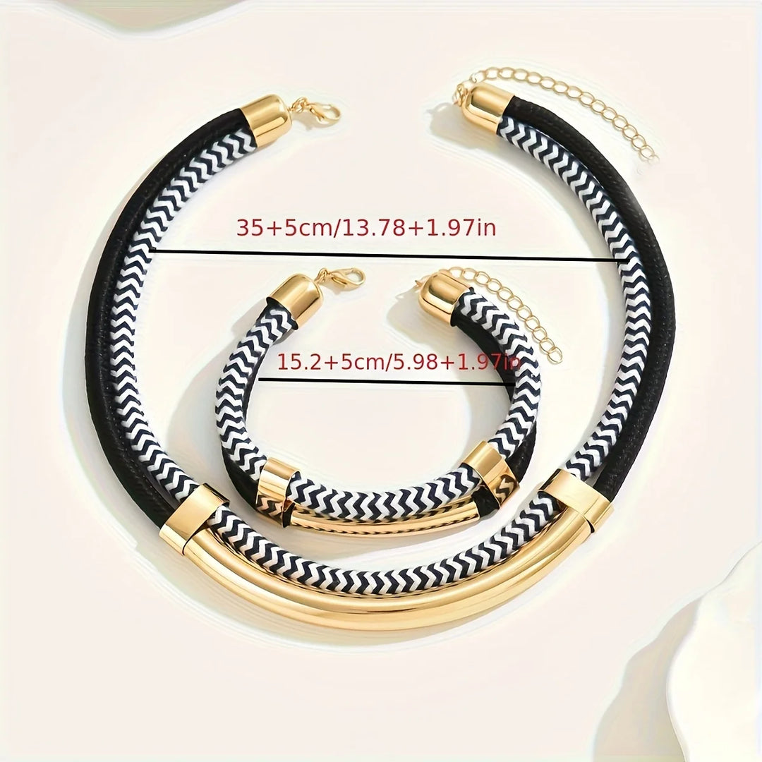 Black and white chevron-patterned necklace with gold accents on a light background