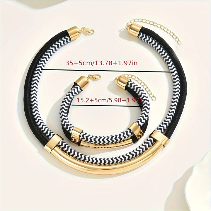 Black and white chevron-patterned necklace with gold accents on a light background