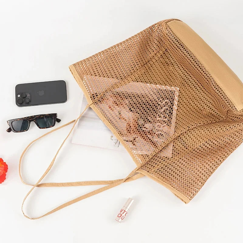 Foldable mesh tote in brown opened flat, showing inner zipped pocket