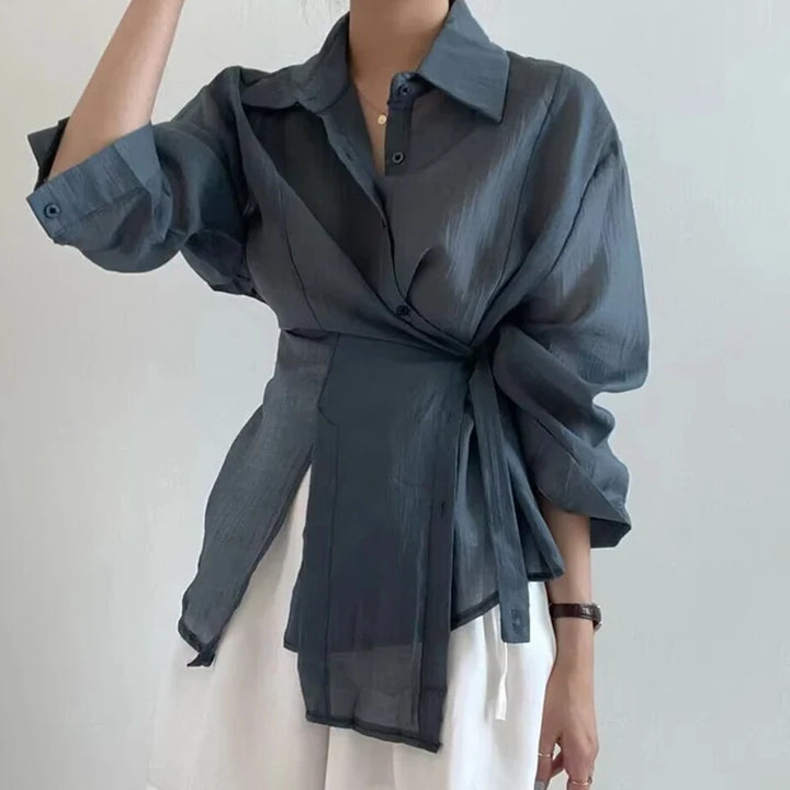 Dark gray shirt with a tie waist on a plain background