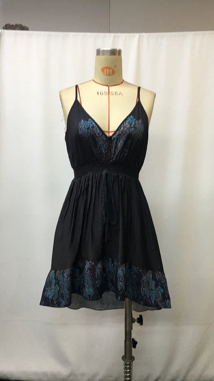 Vintage-style asymmetrical knee-length dress on mannequin: V-neck, gathered waist, tiered hem
