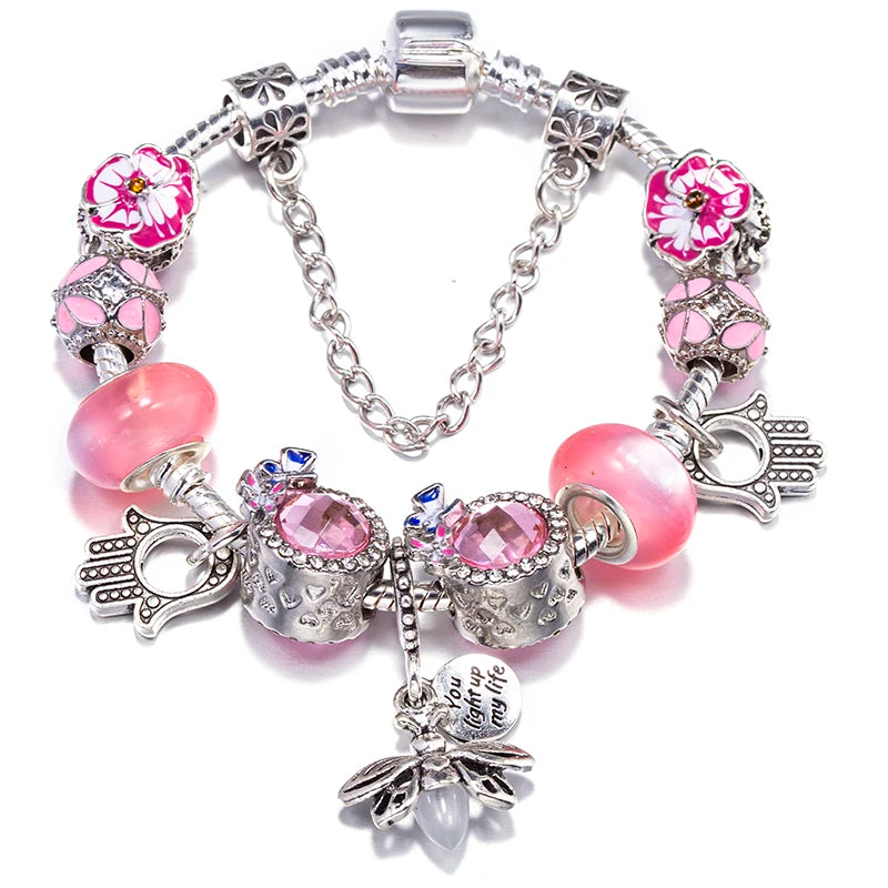 Silver-tone charm bracelet with pink bead, crystal accents, butterfly, and heart pendant