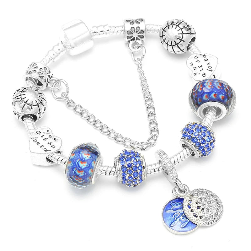 Silver bracelet with blue and multicolor crystal beads, heart pendant, and charm letters