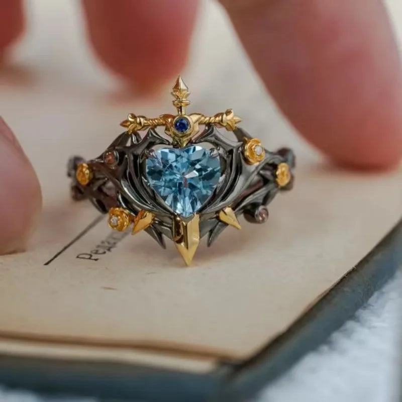 Heart blue zircon ring with gold spikes, dark metal band, adjustable open band