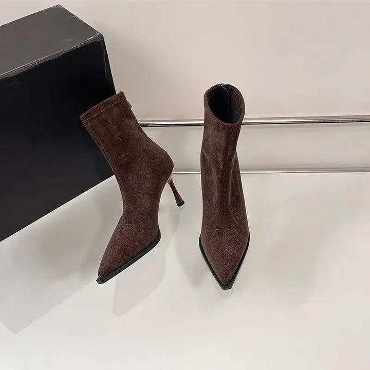 Brown suede ankle boots with pointed toe and slim high heel, side-by-side pair