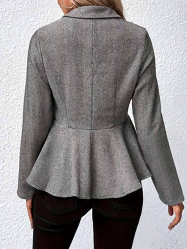 Gray back view trench coat with peplum flare and vertical panel seam.