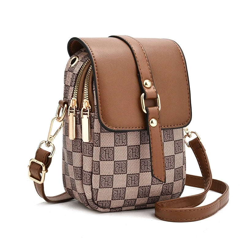Brown and beige checkered handbag with gold accents on a white background