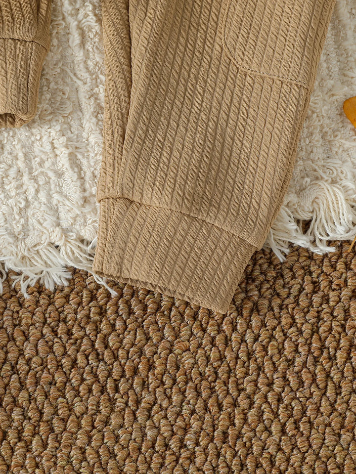 Close-up of a beige textured blanket on a textured surface