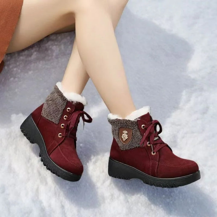 Women’s burgundy lace-up winter boots with faux-fur collar and side emblem badge