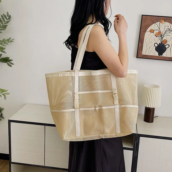 Beige sheer mesh tote bag with open top and wide shoulder straps