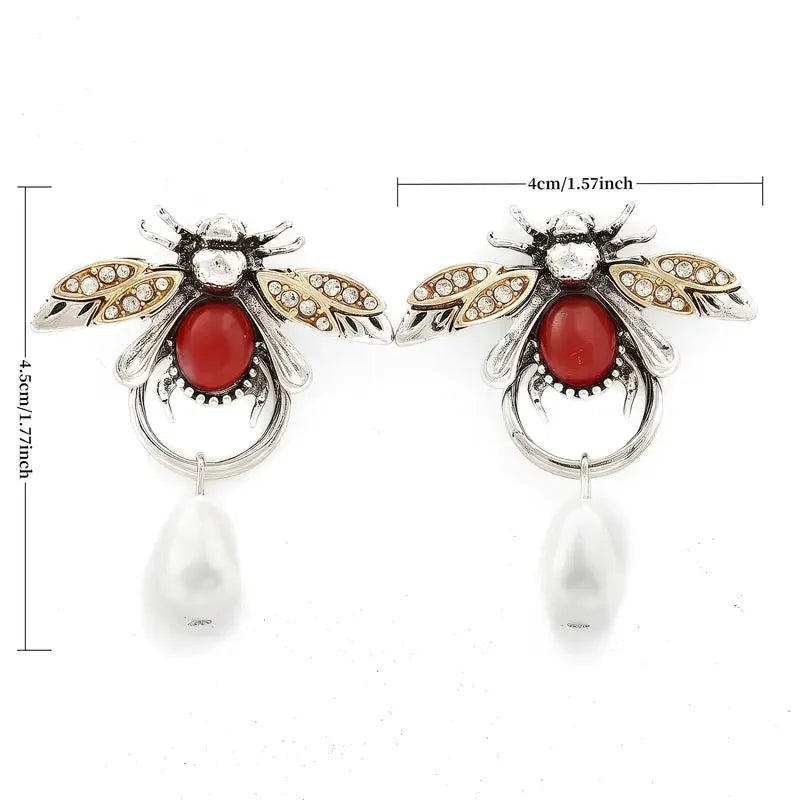 Bee-shaped earrings with red gemstones and pearl drops, shown with measurements on a white background.