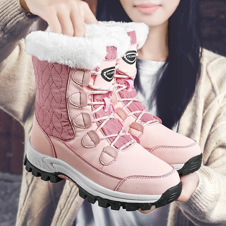 Women's pink mid-calf lace-up snow boots with thick fleece lining and grippy outsole