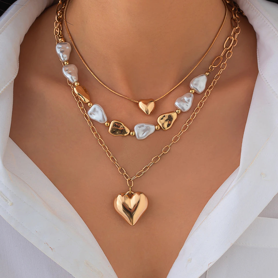 Gold heart-shaped necklace with heart pendants on a mannequin